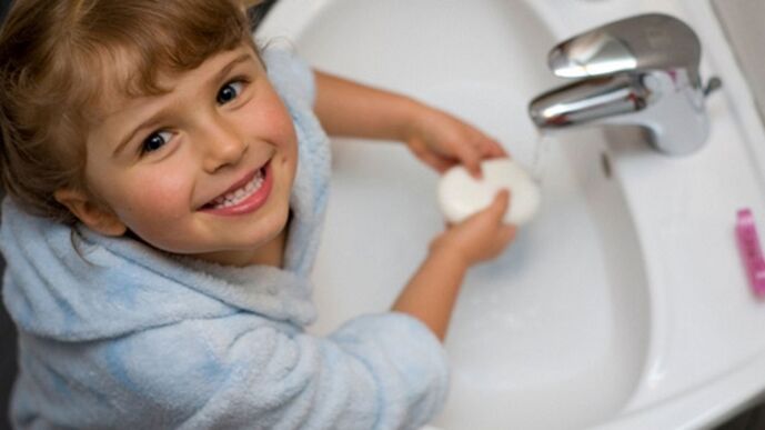 the child washes his hands with soap to prevent worms